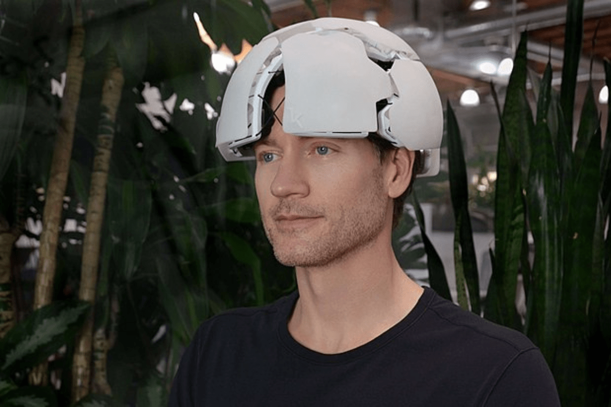 Bryan Johnson wearing a futuristic brain-monitoring device.