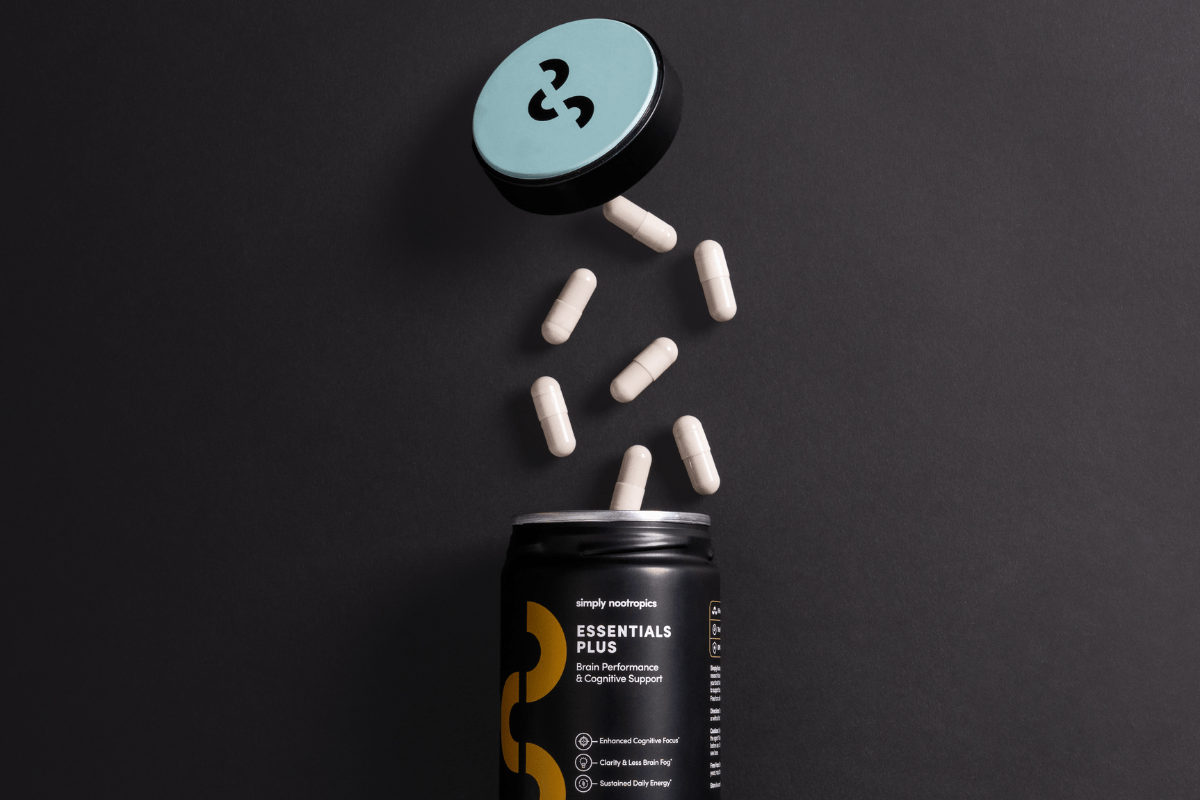 Essentials Plus capsules spilling from a Simply Nootropics container.
