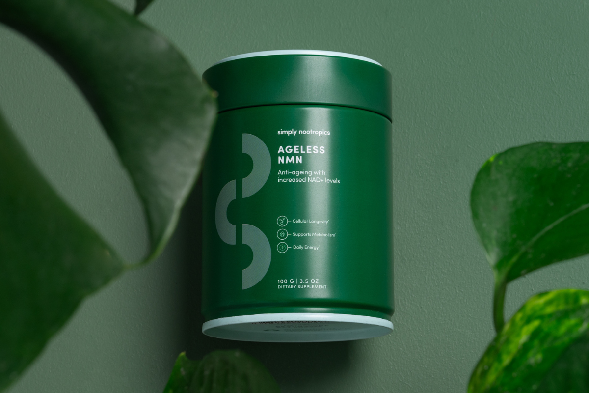 Simply Nootropics Ageless NMN supplement jar surrounded by green foliage.