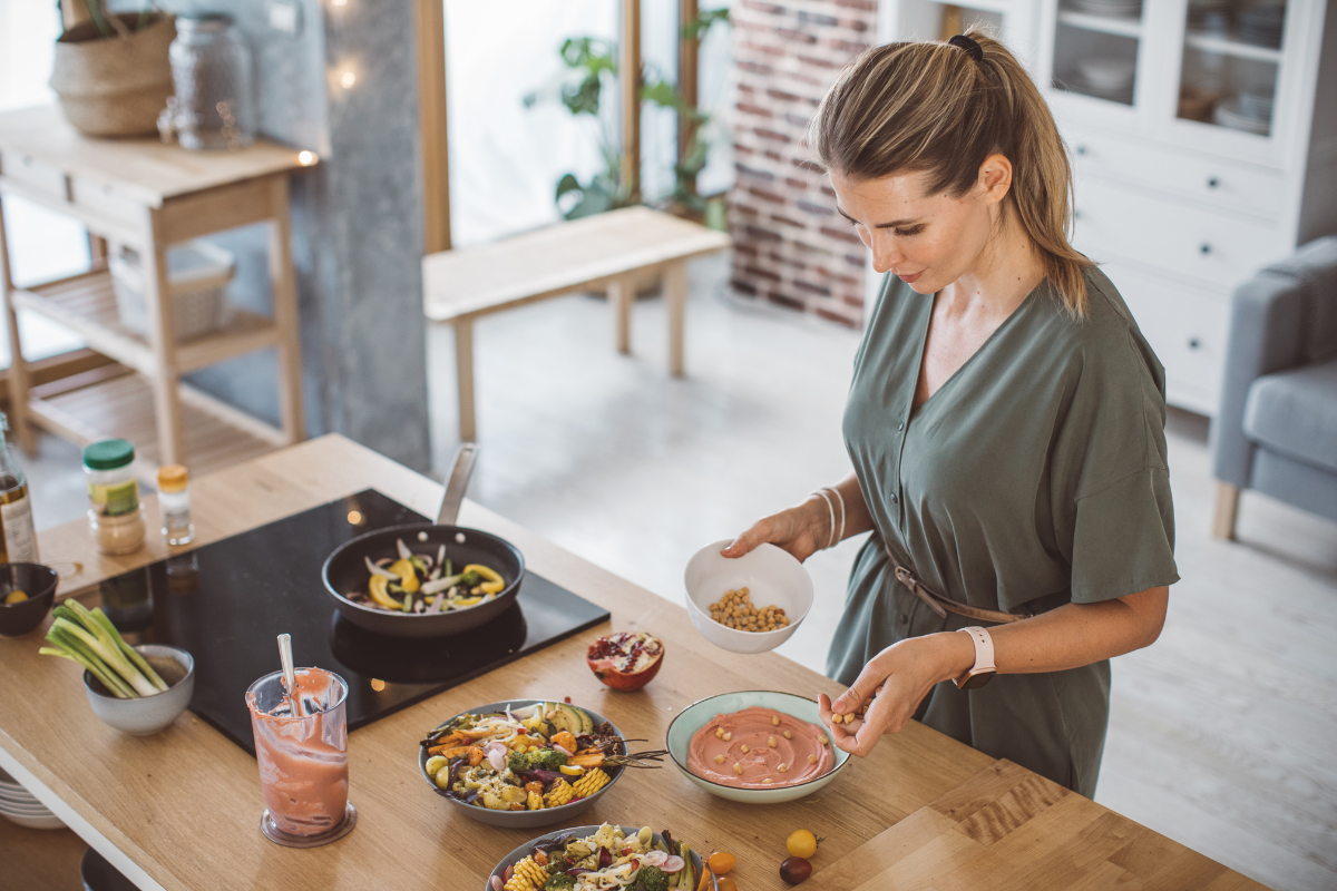 Woman preparing a healthy meal in a modern kitchen.