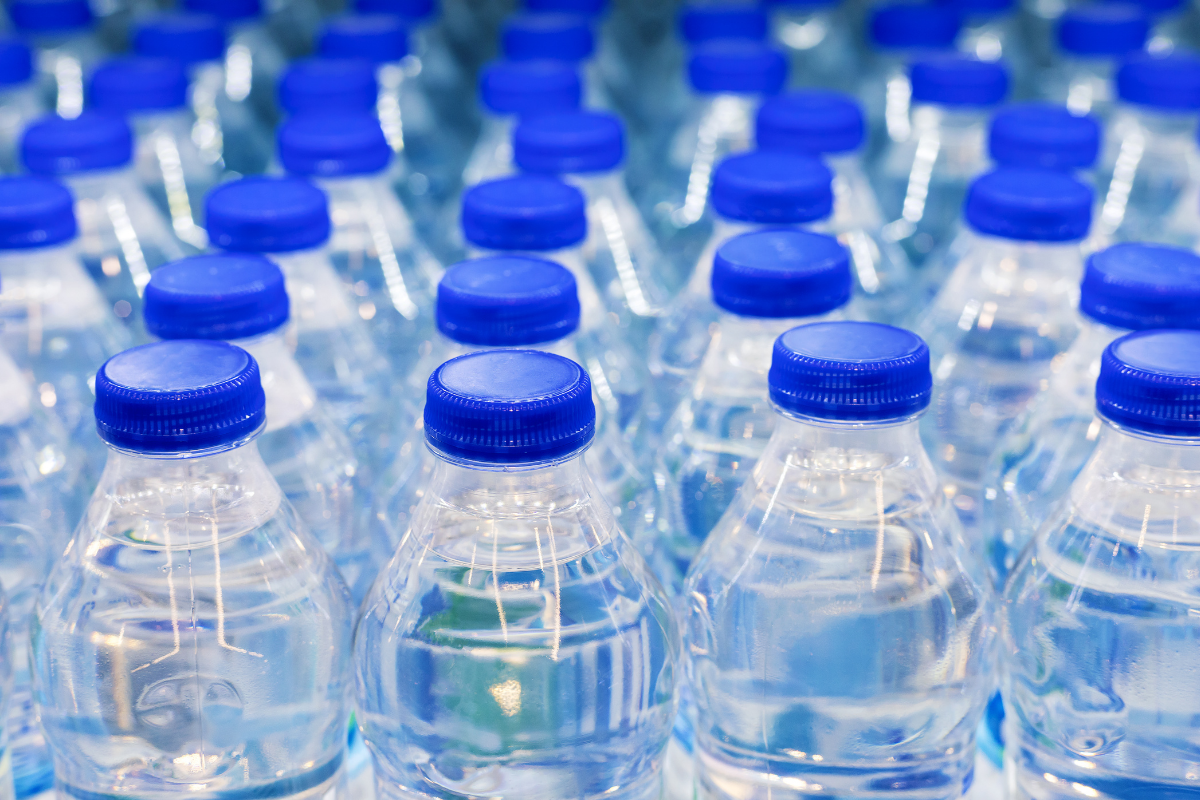 Close-up of plastic water bottles with blue caps.