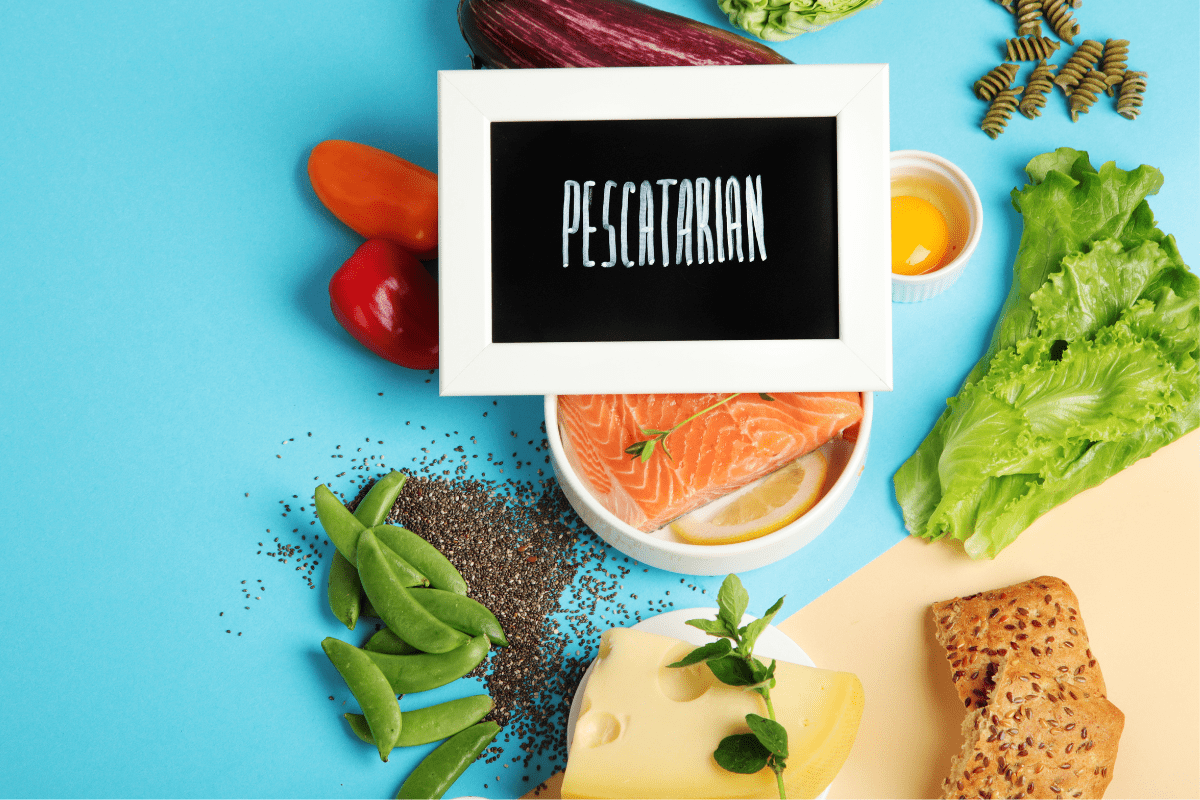 Assorted pescatarian foods, including salmon, lettuce, cheese, eggplant, and chia seeds, with a sign reading 'Pescatarian.