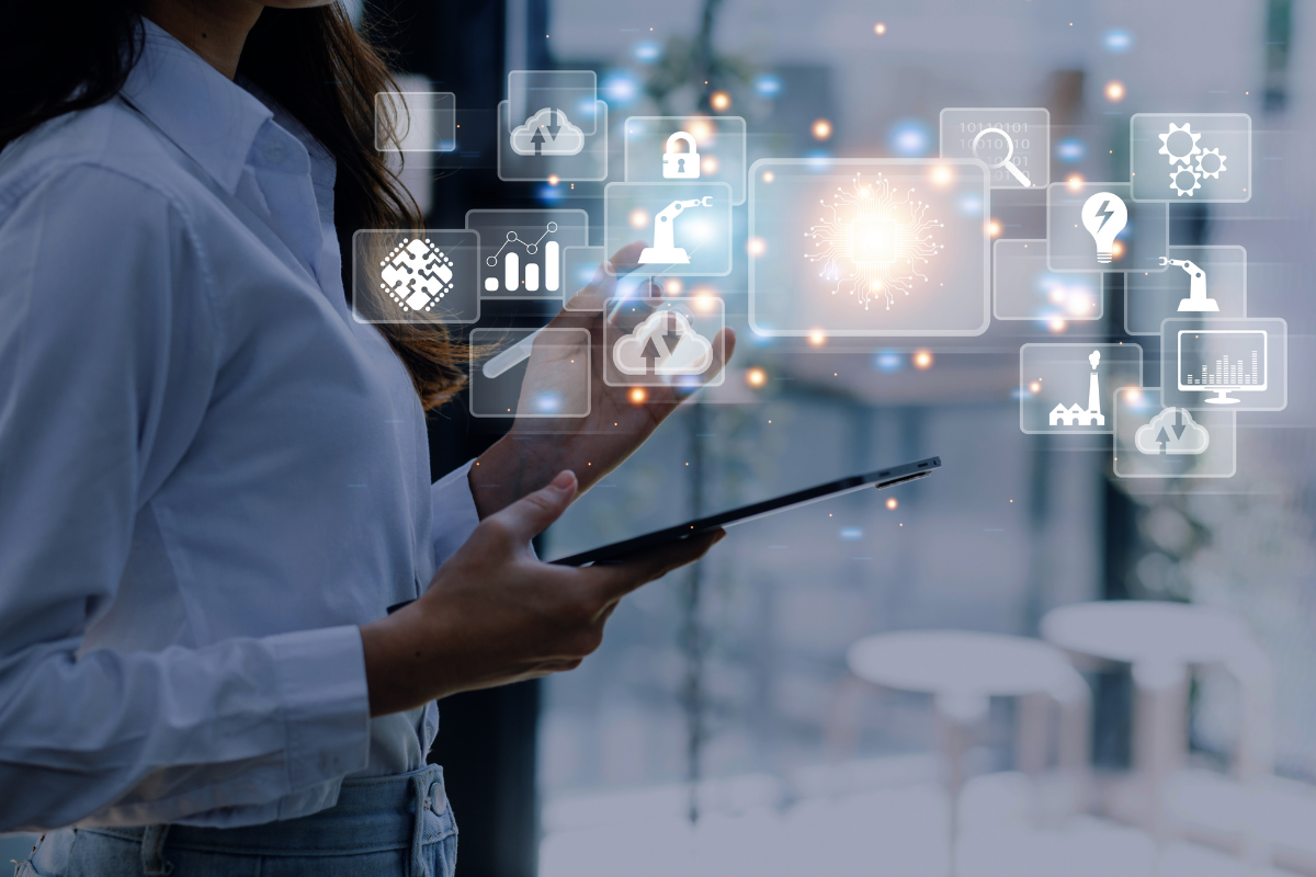 Woman using a tablet with digital icons floating around.