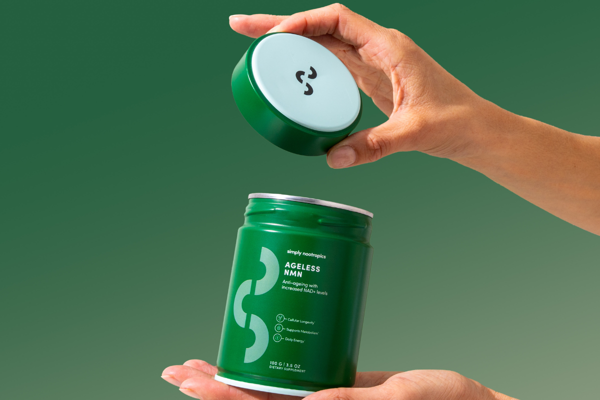 Hands opening green Ageless NMN supplement jar against green background.