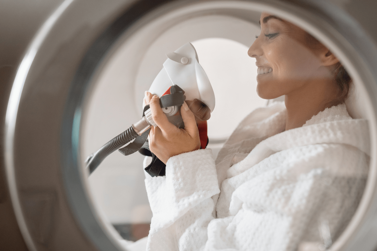 Person undergoing Hyperbaric Oxygen Therapy (HBOT) inside a hyperbaric chamber.