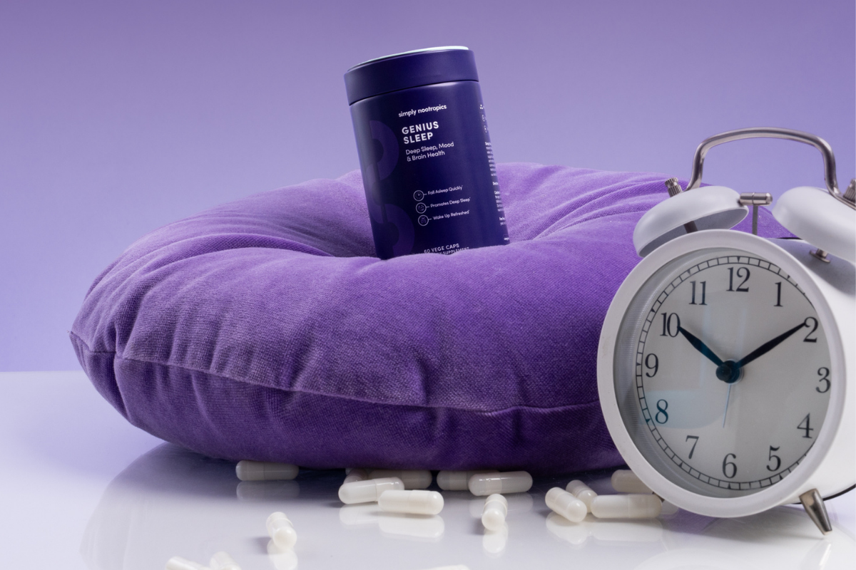 Genius Sleep supplement with capsules, pillow, and clock.