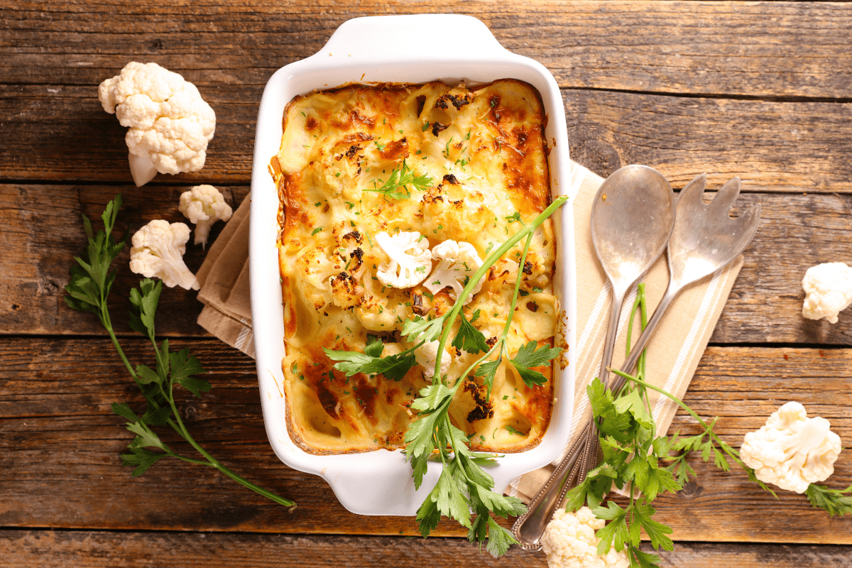 Cheesy cauliflower bake in a white dish.