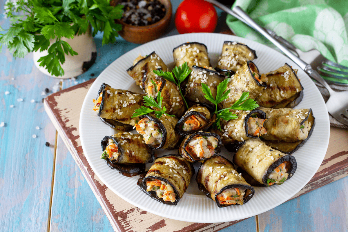 Plate of stuffed eggplant rolls filled with walnut paste.