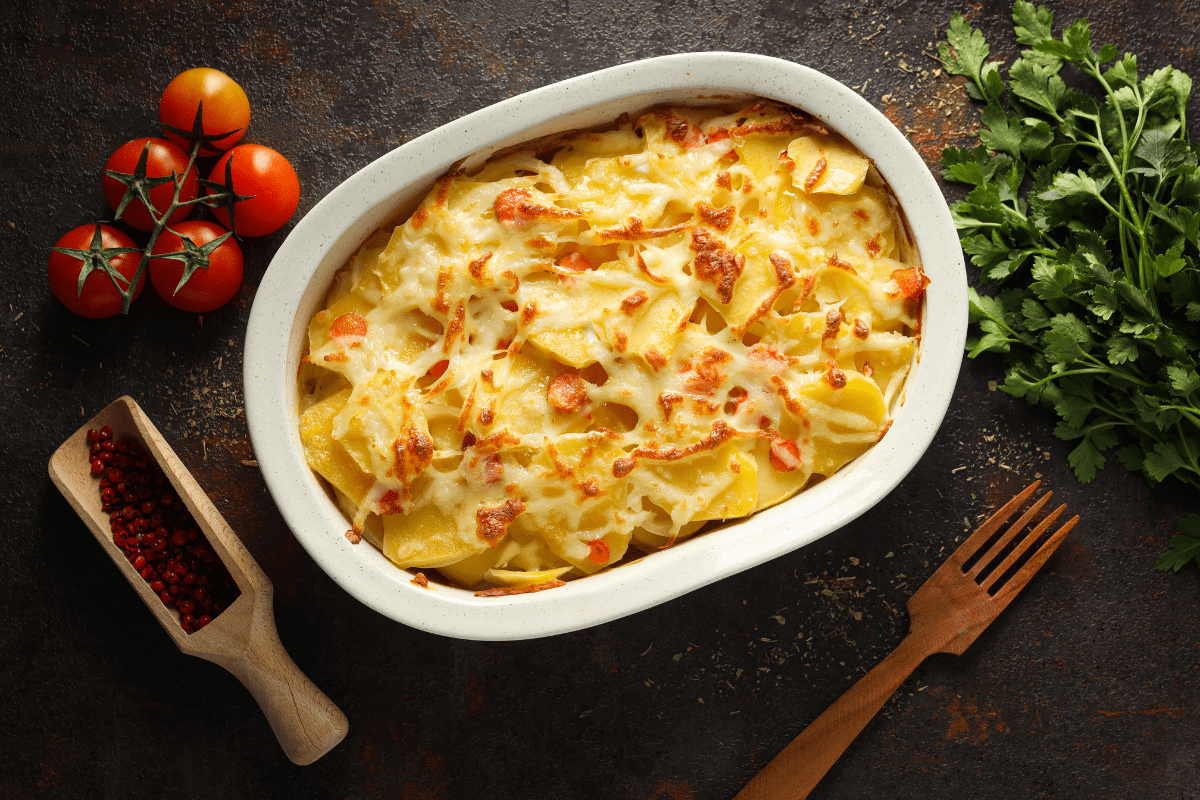 Homemade potato casserole with melted cheese and herbs.