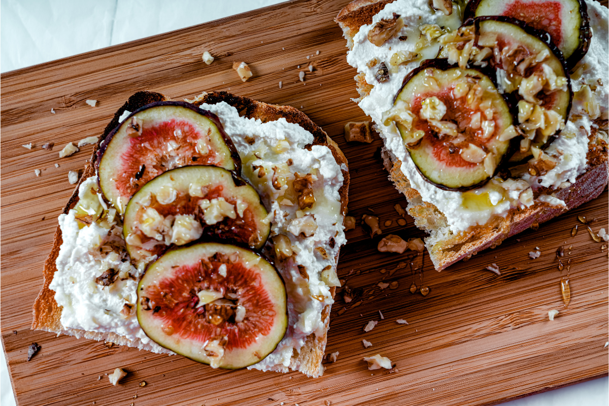 Ricotta toast topped with fresh figs, walnuts, and honey.