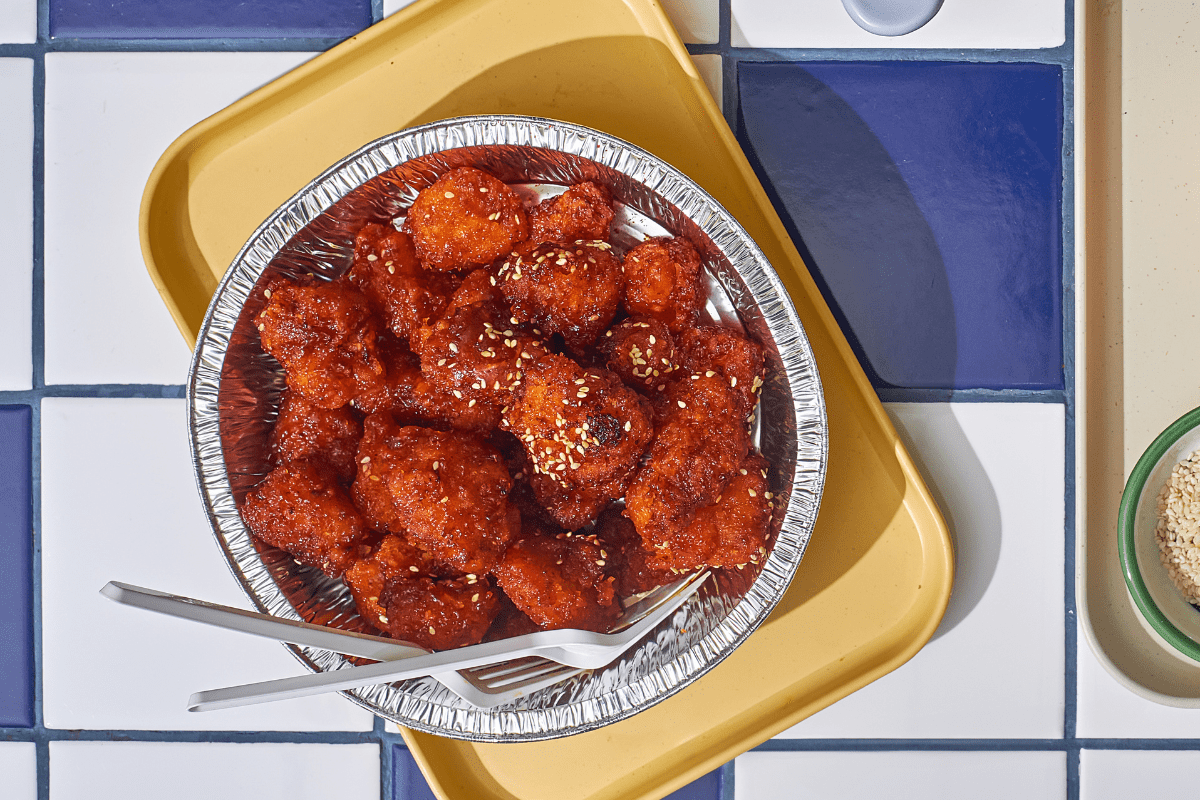 Spicy honey garlic chicken tenders topped with sesame seeds.