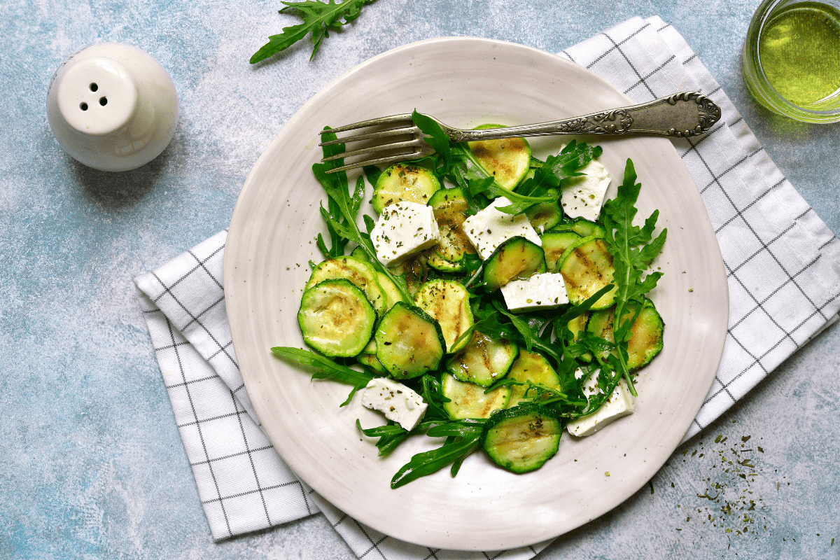 Plate of charred zucchini salad with feta cheese.